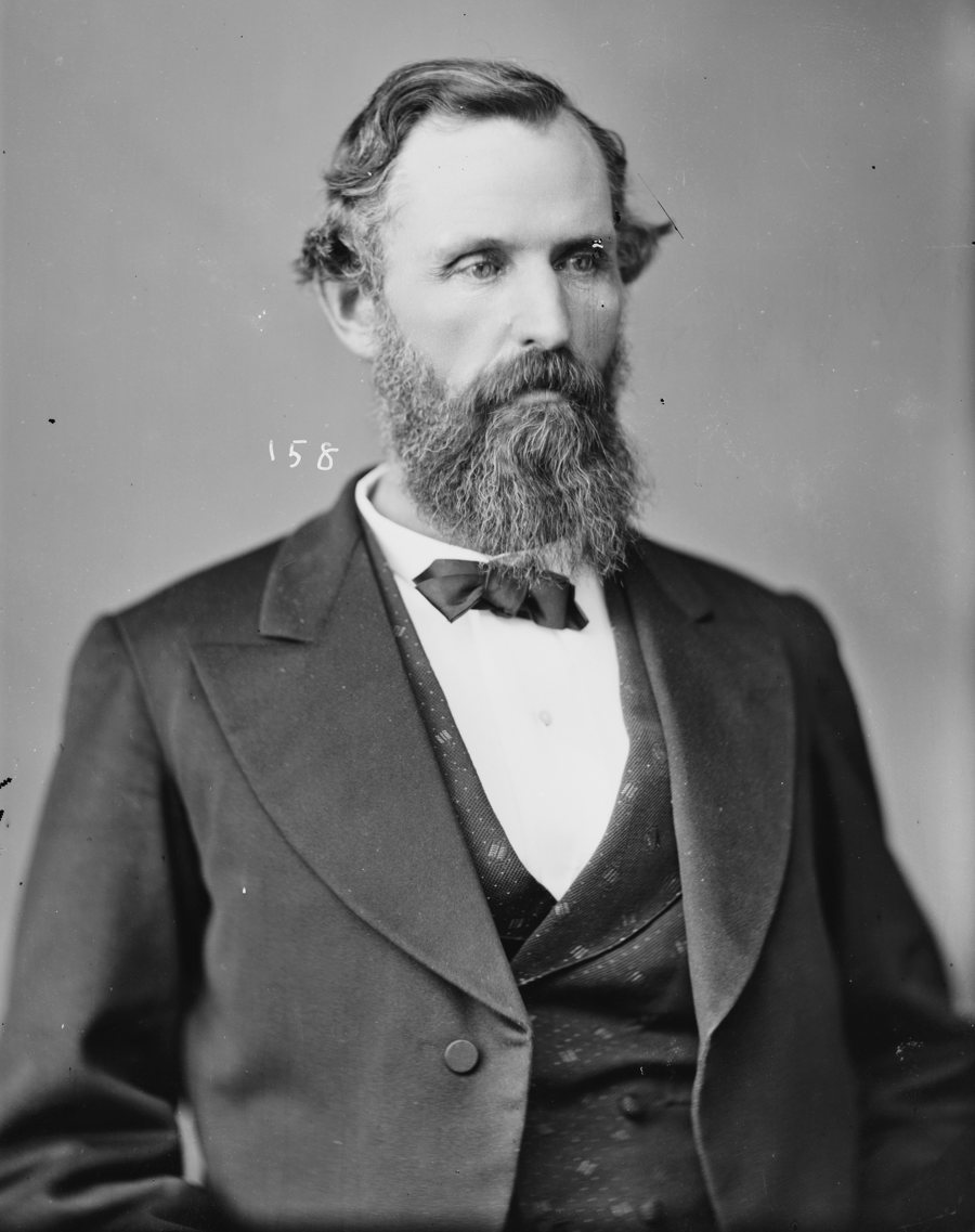 Black-and-white studio portrait of Hiram Parks Bell, a bearded man in a dark suit, waistcoat and bow tie, turned slightly to his left.